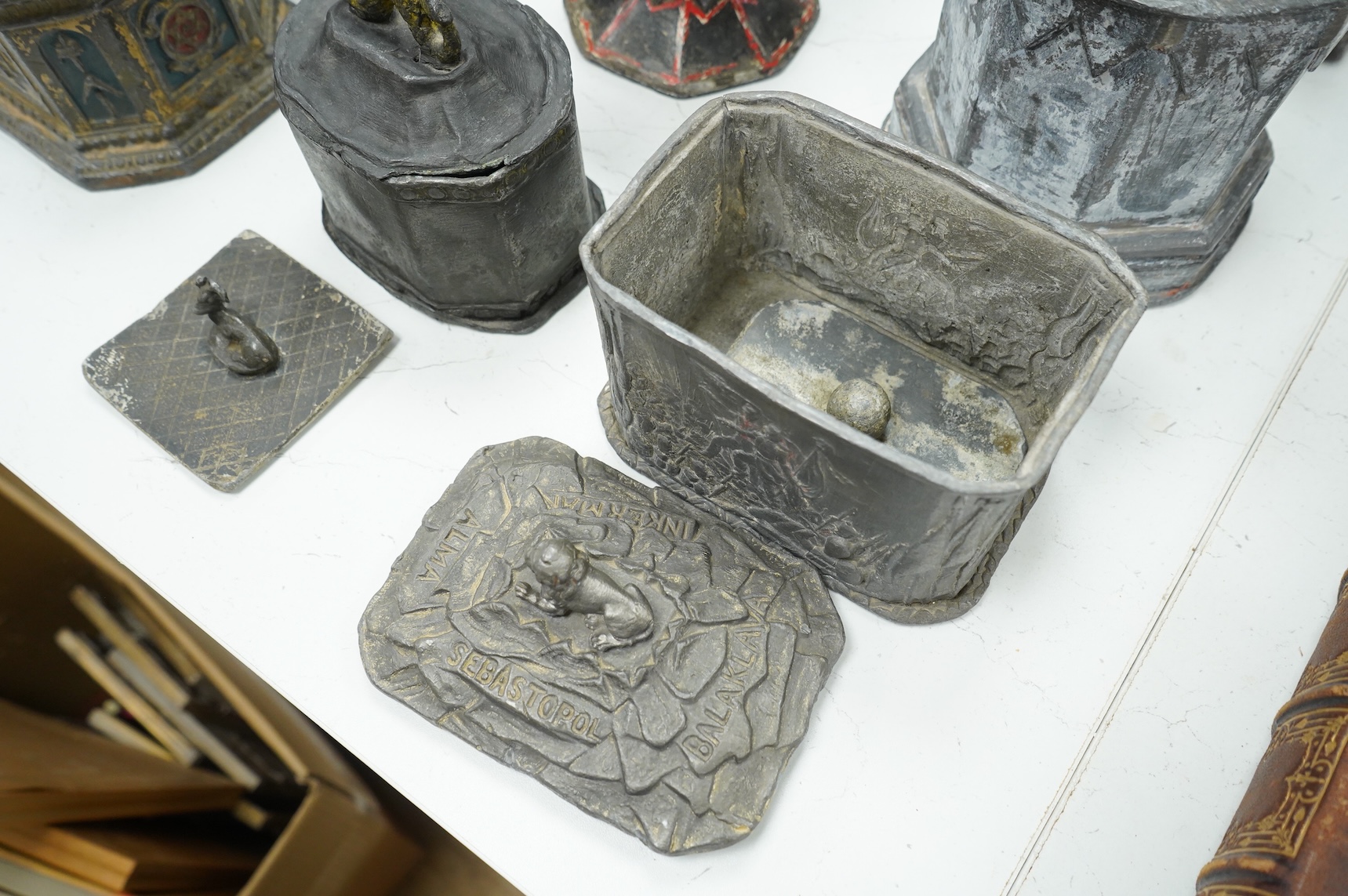 A collection of nine early 19th century lead tobacco boxes and a cover, tallest 20cm